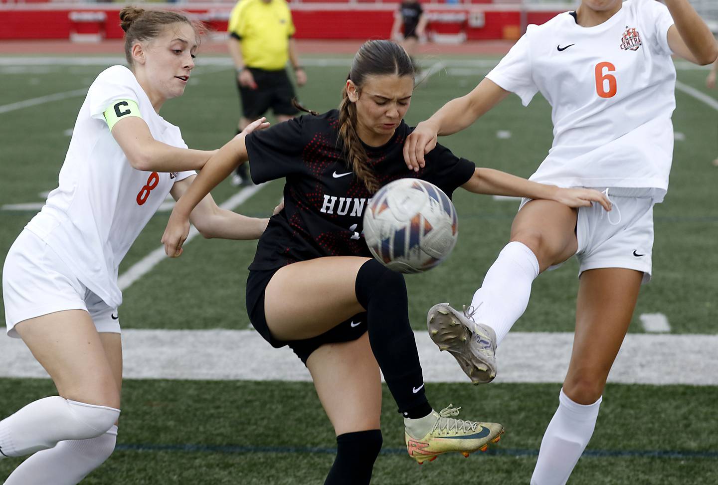Huntley's Mia Moyer (center) tries control the bal between Crystal Lake Central's Peyton McMahon (left) and Ella Bechler during a Fox Valley Conference soccer match on Tuesday, April 14, 2026, at Huntley High School.