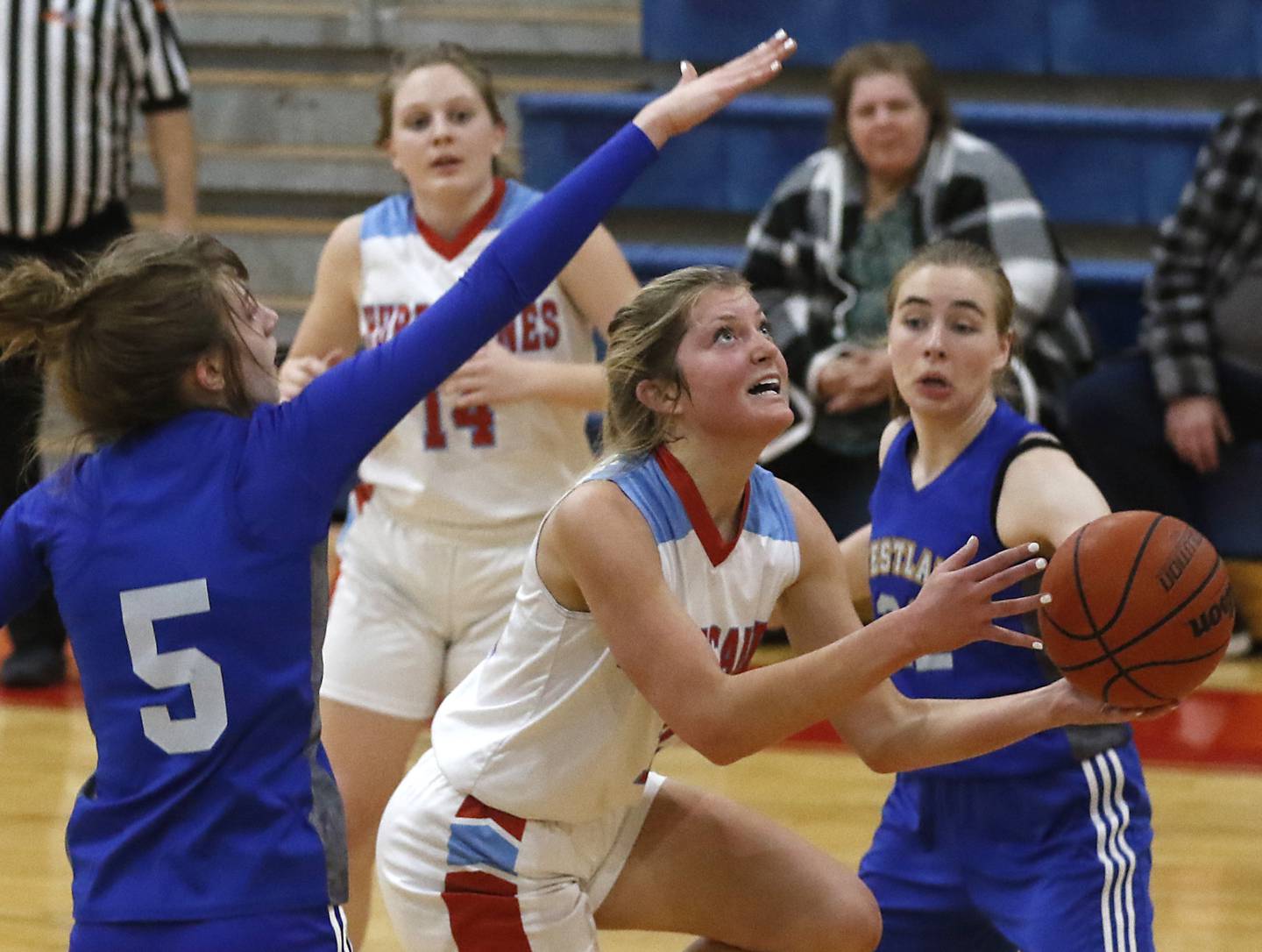 Marian Central's Madison Kenyon drives to the basket between Westlake Christian’s Juliette Sigurnjak and Megan Anderson during a non-conference girls basketball game Monday, Feb. 6, 2023, at Marian Central High School  in Woodstock.