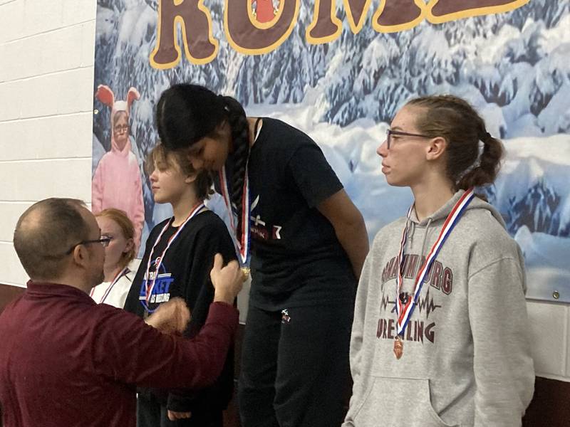 Alejandra Flores of Bolingbrook is presented with the first place medal at the Morris Reindeer Rumble alongside Madyson Meyer (right), Victoria Macias (left) and Makensi Martin (far left).