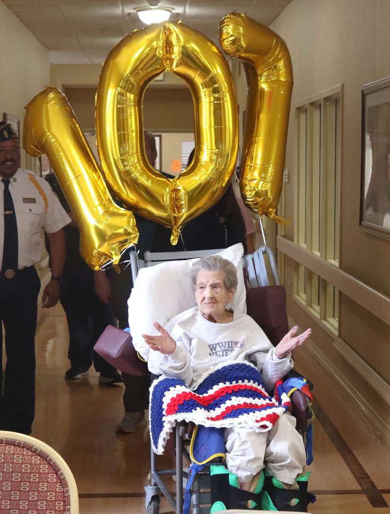 World War II veteran Myrtle Annetta Lusiak enters her birthday party Thursday, May 2, 2024, at Aperion Care in DeKalb. Lusiak, who was honored Thursday with gifts and proclamations, was celebrating her 107th birthday and served in the Women’s Army Corps from Aug. 5, 1943 until her honorable discharge on Nov. 27, 1945.