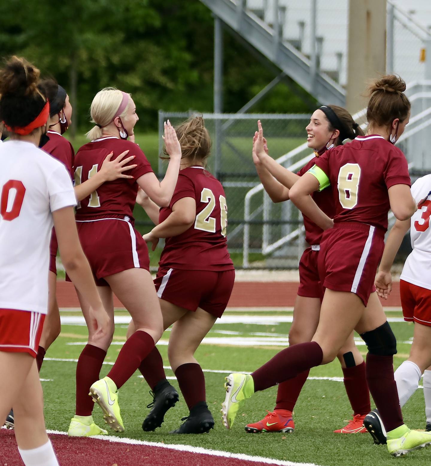 Morris' Emilia Marino (11) is congratulated by teammates Tuesday, May 25, 2021, after scoring a goal in a 6-1 win over Ottawa.