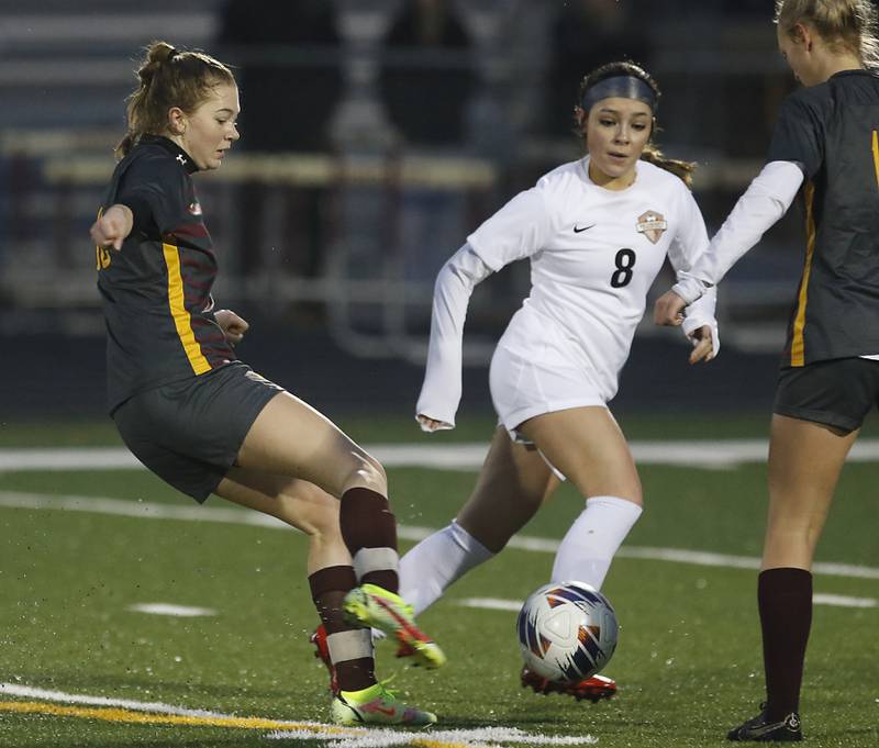 Richmond-Burton’s Rachel Mendlik takes a shot on goal as McHenry’s Elena Carlos defends during a non-conference girls soccer match Thursday, March 16, 2023, at Richmond-Burton High.