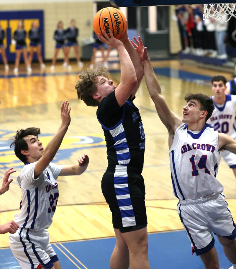 Hinckley-Big Rock's Luke Badal gets up a shot between two Ida Crown defenders during their Class 1A sectional game Wednesday, March 5, 2025, at Somonauk High School.