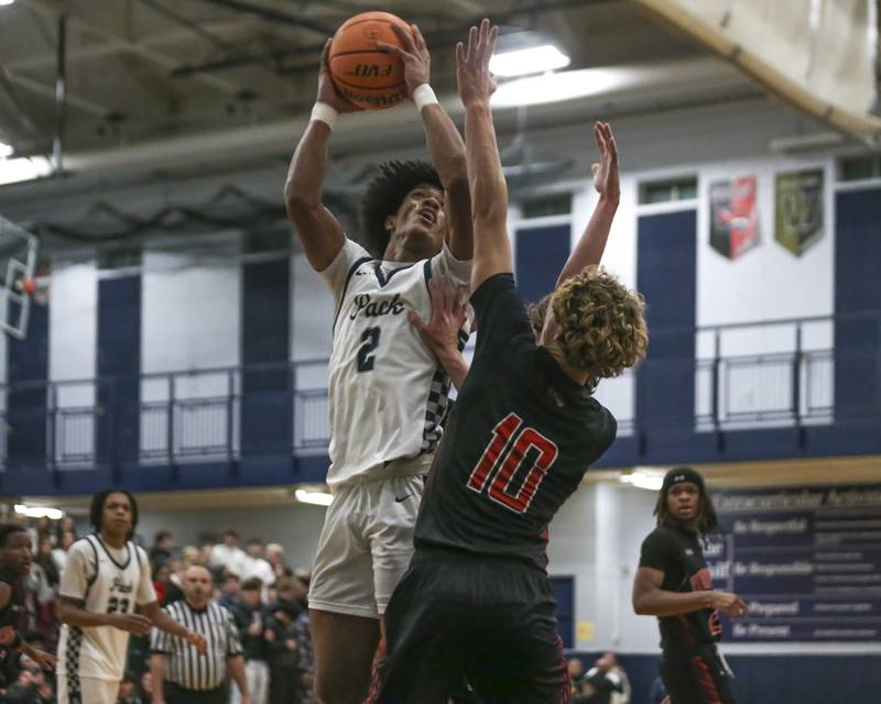 Oswego East's Jacsen Tucker (2) puts up a shot from the post during their basketball game between Yorkville at Oswego East. Friday, Dec 19, 2025 in Oswego.