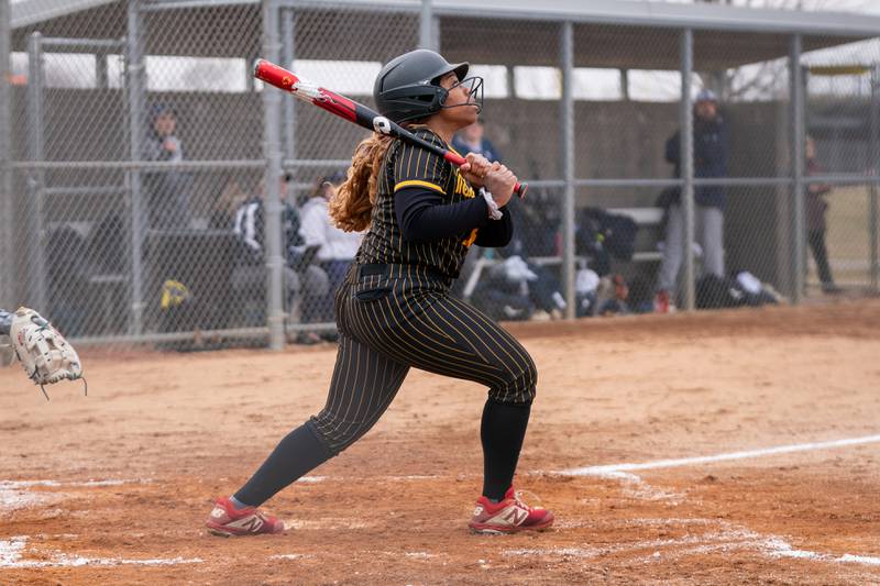 Metea Valley's Claire Desrosiers (16) drives in a run against Oswego East during a softball game at Metea Valley High School in Aurora on Friday, Mar 24, 2023.