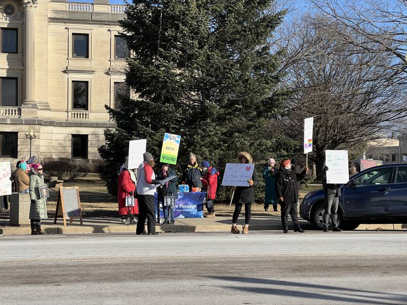 Women hold signs advocating women-led issues including abortion access, and an end to domestic violence. Safe Passage, a DeKalb-based organization dedicated to promoting everyone's right to abuse-free relationships, organized a women's rights march on Saturday, Jan. 18, 2025, in front of the DeKalb County Courthouse in downtown Sycamore.
