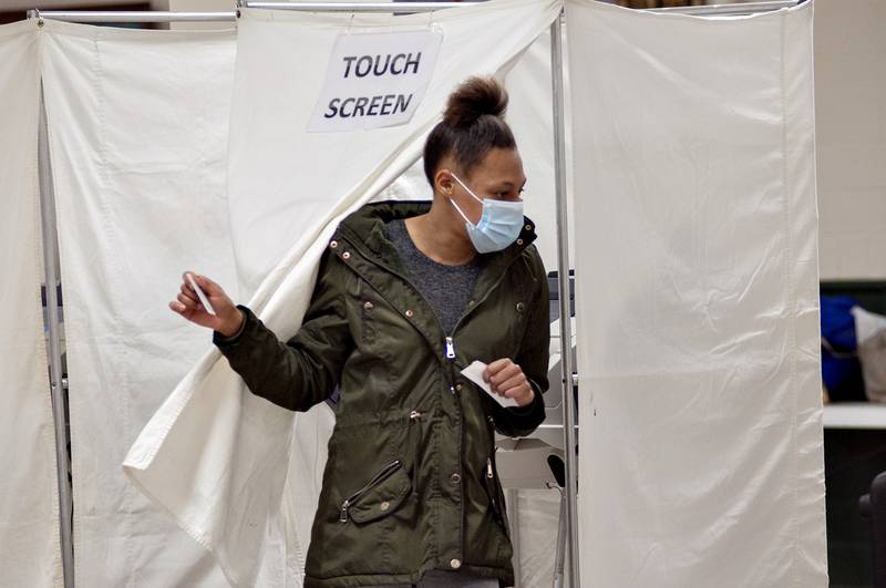 Shante Monroe exits the voting booth Tuesday after casting her ballot at the Loveland Building in Dixon during Tuesday's general election.