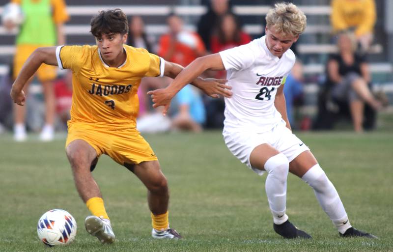 Jacobs’  Cristian Varela, left, battles Prairie Ridge’s Bryce Schroeder in varsity soccer at Jacobs High School in Algonquin on Thursday, Sept. 18, 2025.