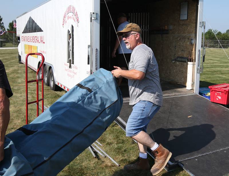 Dennis Znaniecki, commander of post 375 in Peru, carries materials that hold the Vietnam Traveling Memorial Wall on Thursday, Aug. 24, 2023 at Veterans Park in Peru. "It took 8 months of planning to get bring the wall to Peru," said Znaniecki. "Thirty-three people are on the wall. who parished from the Vietnam War from La Salle County" Znanieki added. The wall is a 3/5 scale of the Vietnam Memorial in Washington, D.C and stands 6 feet tall, and spans nearly 300 feet wide.Along with the Vietnam Traveling Memorial Wall, residents will have the opportunity to view a replica of the Middle East Conflicts Wall in Marseilles, and the 9/11 first responders wall. Visitors can see the wall through Sunday in Peru.