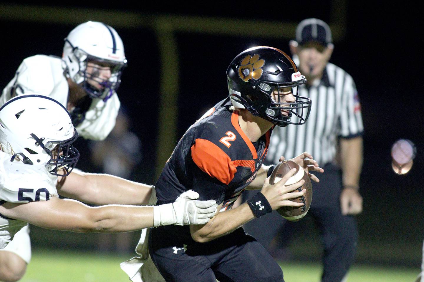 Crystal Lake Central’s Jason Penza tries to elude Cary-Grove’s Ty Drayton in varsity football at Metcalf Field in Crystal Lake Friday night.