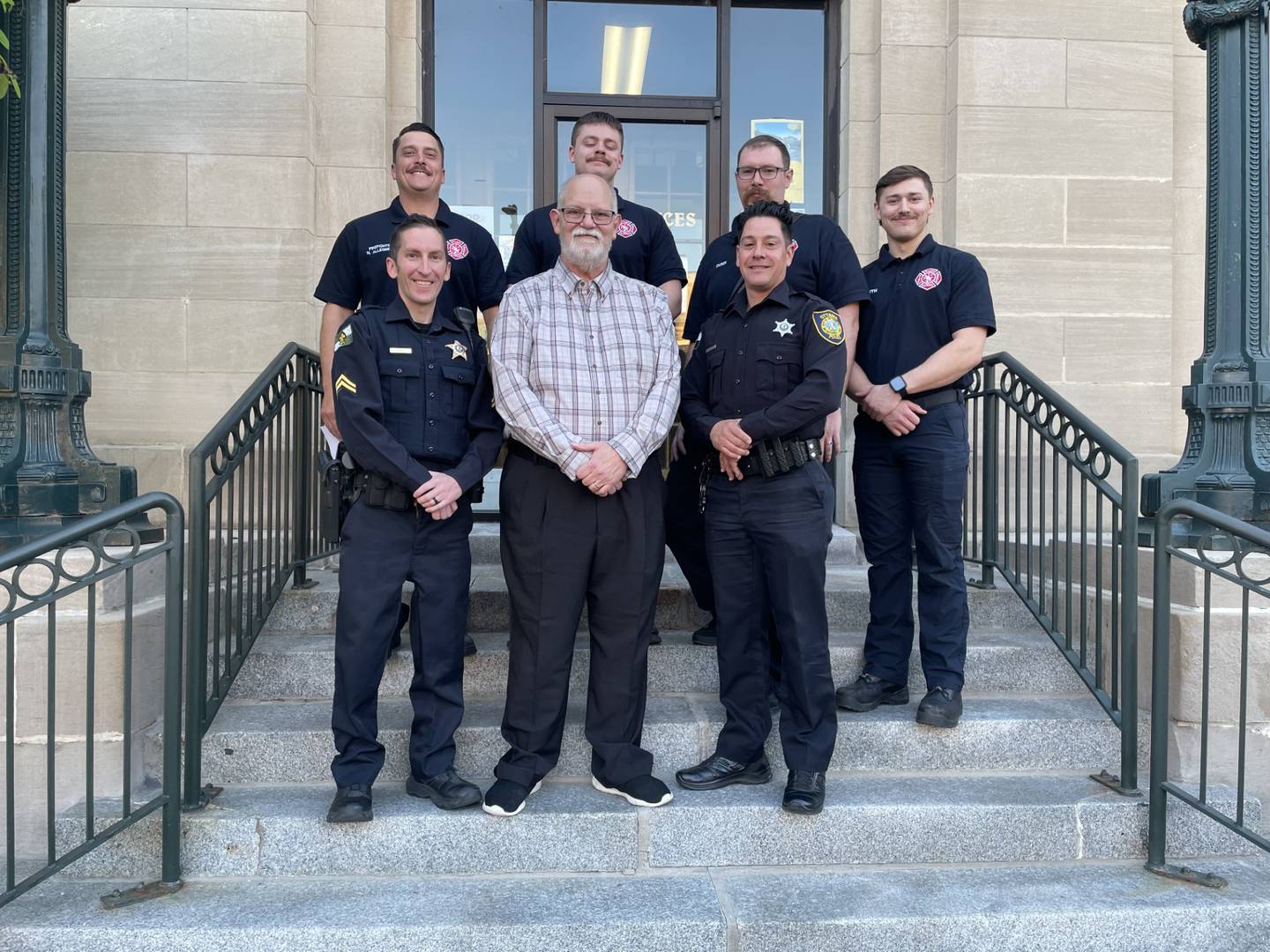 Ottawa police officers and firefighters who were honored for their lifesaving response to a March 31 medical emergency pose for a photo outside Ottawa City Hall during the City Council meeting Tuesday, May 6, 2025. The group received letters of commendation after helping save a man who suffered cardiac arrest.