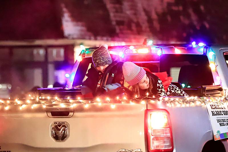 The 2025 Erie Little Miss Adaline Gool and Mister Alaric Gool throw candy to the spectators during the annual Christmas Parade Saturday, Dec. 7, 2025, in Erie.