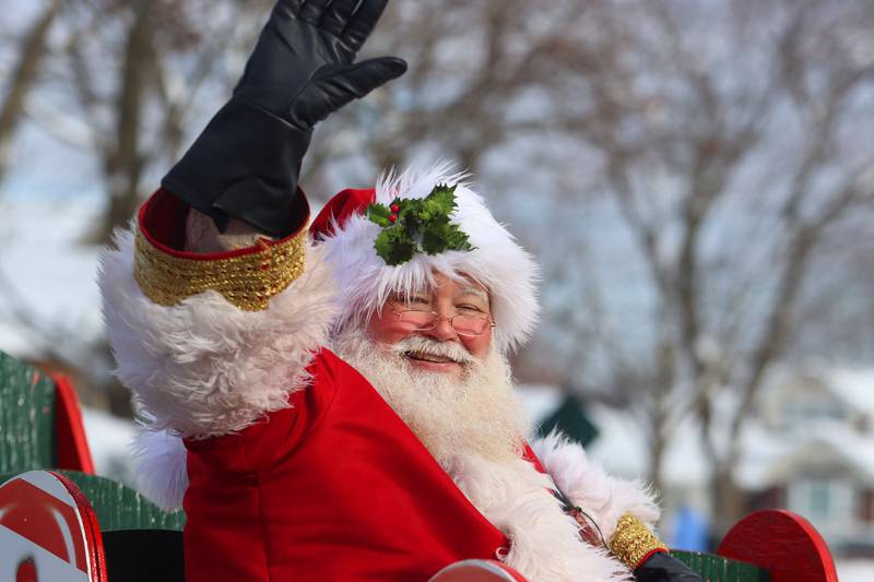 Santa greets parade goers  during the Merry Cary Christmas Parade in Cary on Sunday, Dec. 7, 2025 in Cary.
