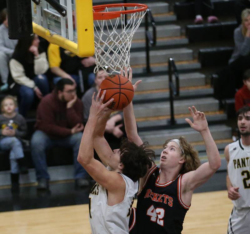 Putnam County's Orlando Harris runs in front of Roanoke-Benson's Zeke Kearfott to score a basket during the Tri-County Conference Tournament on Tuesday, Jan. 24, 2023 at Putnam County High School.