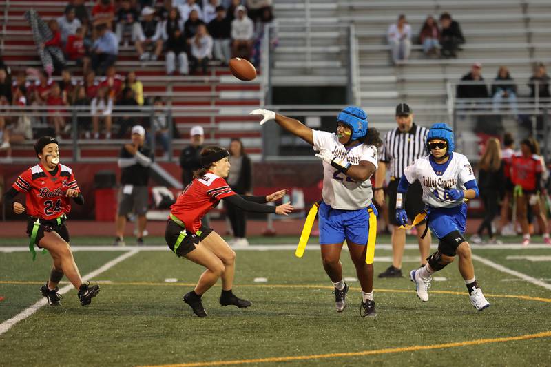 Joliet Central's Georgianna Majerus passes under pressure from Bradley-Bourbonnais defenders during the Boilermakers' 60-7 victory over Joliet Central in the season opener on Aug. 25, 2025.
