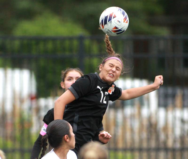 Wheaton Warrenville South's Lucy Jethani heads the ball during a Class 3A Glenbard West Sectional semifinal game against Glenbard West on Tuesday, May 27, 2025 in Glen Ellyn.
