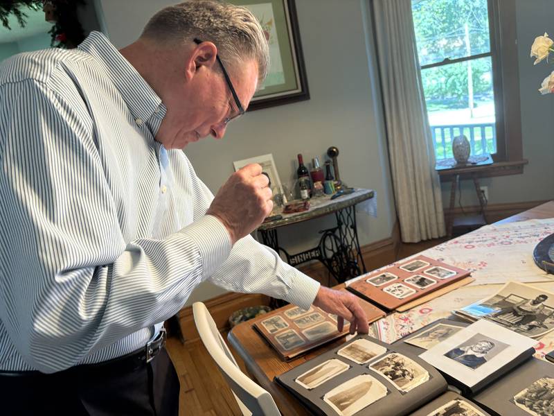 Mark Hutson looks at contents of James Baker's military trunk May 23, 2025 in Woodstock.