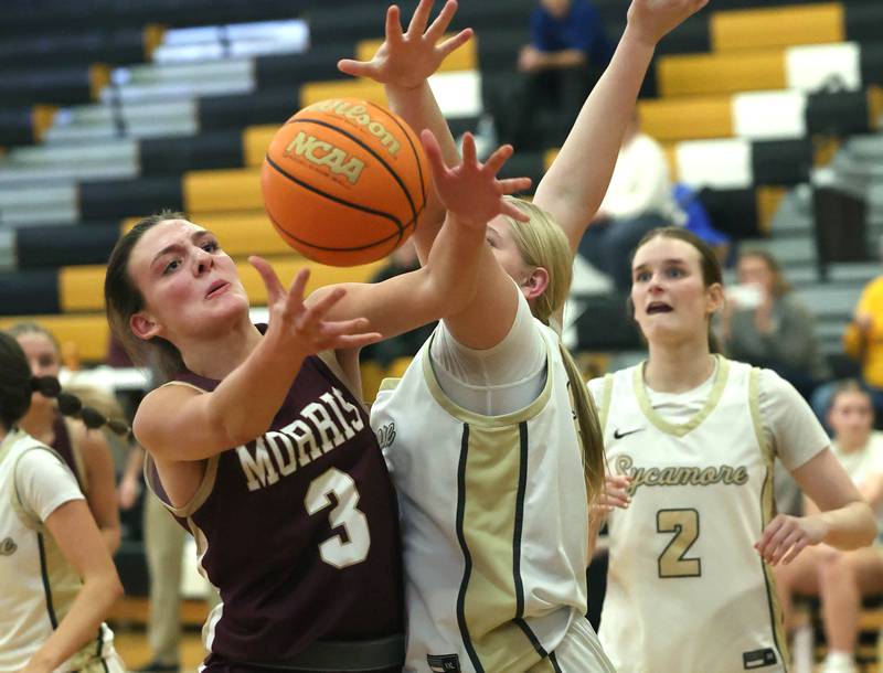 Morris' Lily Hansen grabs a rebound in front of Sycamore's Camryn Knox during their game Tuesday, Jan. 13, 2026, at Sycamore High School.
