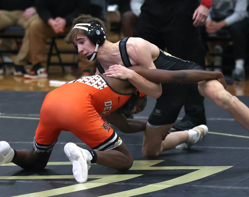 Sycamore’s Michael Olson wrestles DeKalb’s Sam Howard at 120 pounds Friday, Jan. 16, 2026, at Sycamore High School.