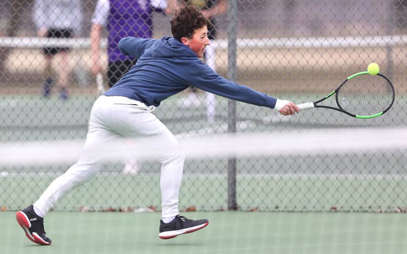 Dixon’s number one singles player Bashar Elbzour reaches for a backhand during his match against Sycamore Thursday, March 30, 2023, at Sycamore High School.
