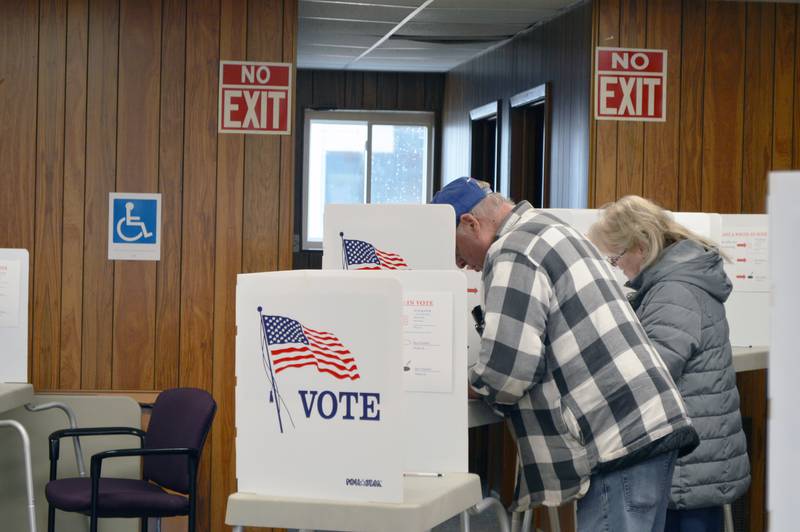 Melvin Schaar, left, and Penny Swift cast their ballots for the consolidated election in the Forreston Township building on April 4, 2023. About 80 people had voted in the precinct as of 3:06 p.m.