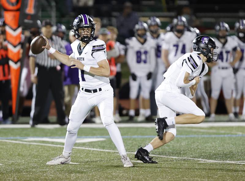 Downers Grove North's Owen Lansu (1) looks for a receiver during the varsity football game between Downers Grove North and York on Friday, Oct. 4, 2024 in Elmhurst.