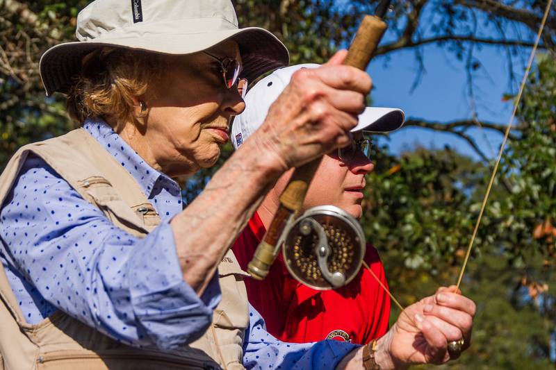 Former First Lady Rosalynn Carter fly fishes with Voice of America Kane Farabaugh, of Ottawa.