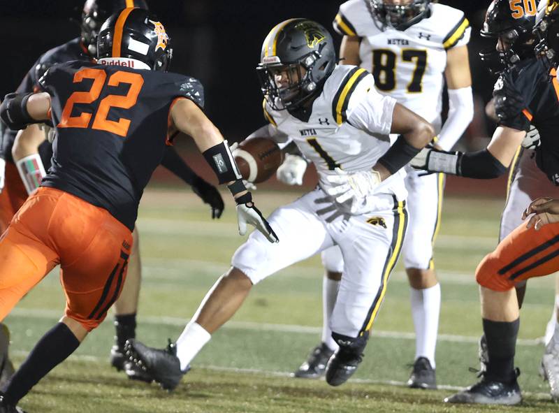 Metea Valley's Amari Chairs looks to get by DeKalb's Aiden Sisson during their game Friday, Sept. 16, 2022, at DeKalb High School.