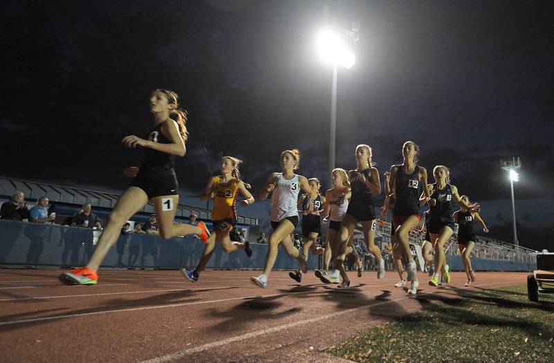 St. Charles North’s Kara Glenn leads the pack at the start of the 3,200-meter run at the IHSA Class 3A Hoffman Estates girls track and field sectional meet in Hoffman Estates on Thursday, April 15, 2025.