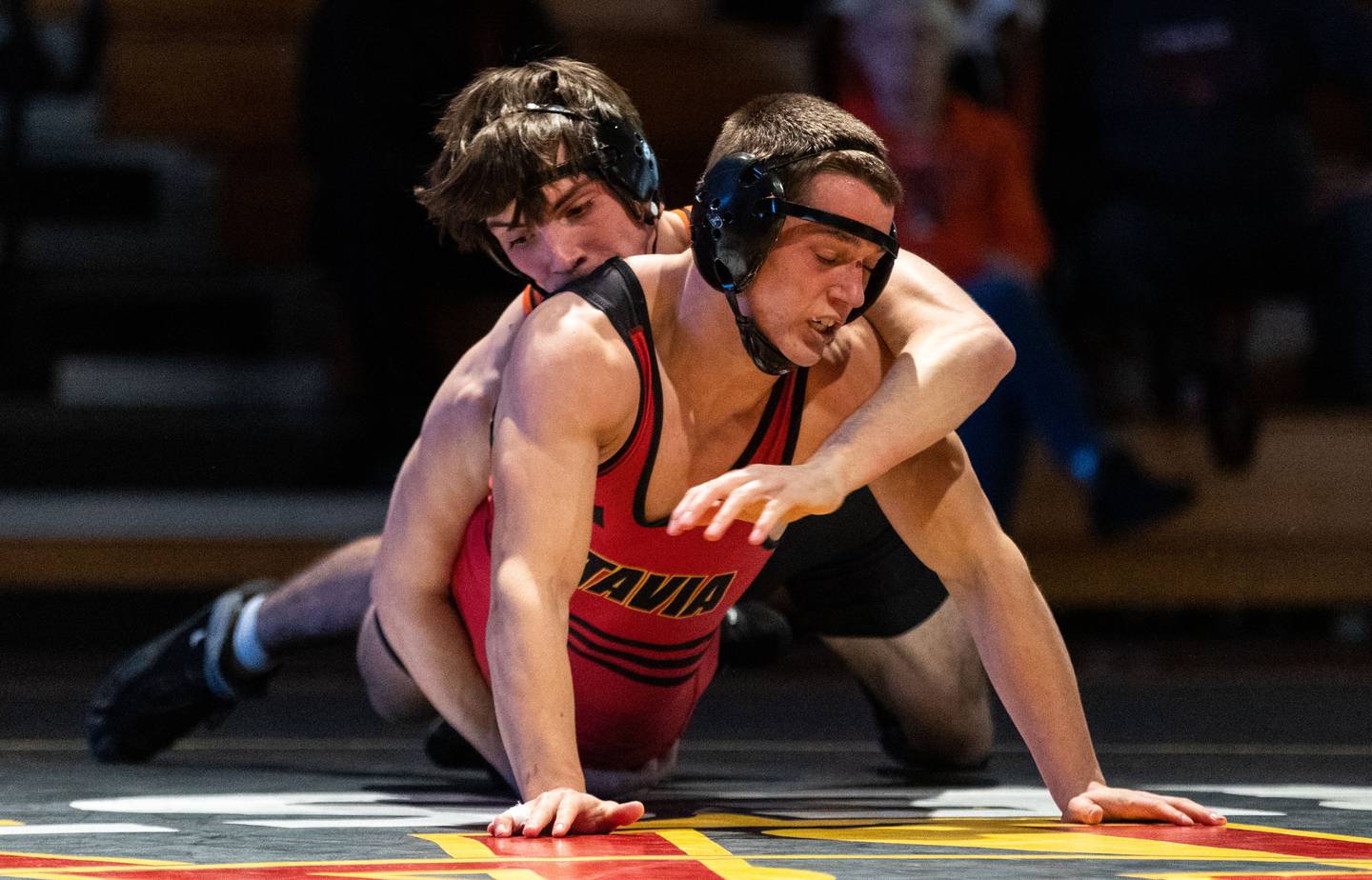 St. Charles East’s Ryan McGovern (right) takes down Batavia’s Michael Lacina during a varsity wrestling dual at Batavia High School on Friday, Jan. 10, 2025.