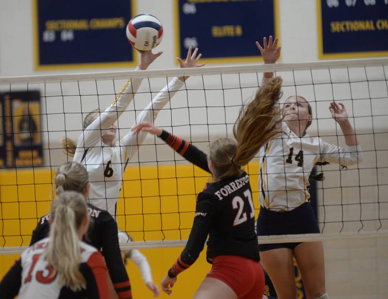 Forreston's Jenna Schneiderman spikes as Polo's Syndei Rahn (6) and Courtney Grobe (14) block during a Thursday, Sept. 7, 2023 match at Polo High School.
