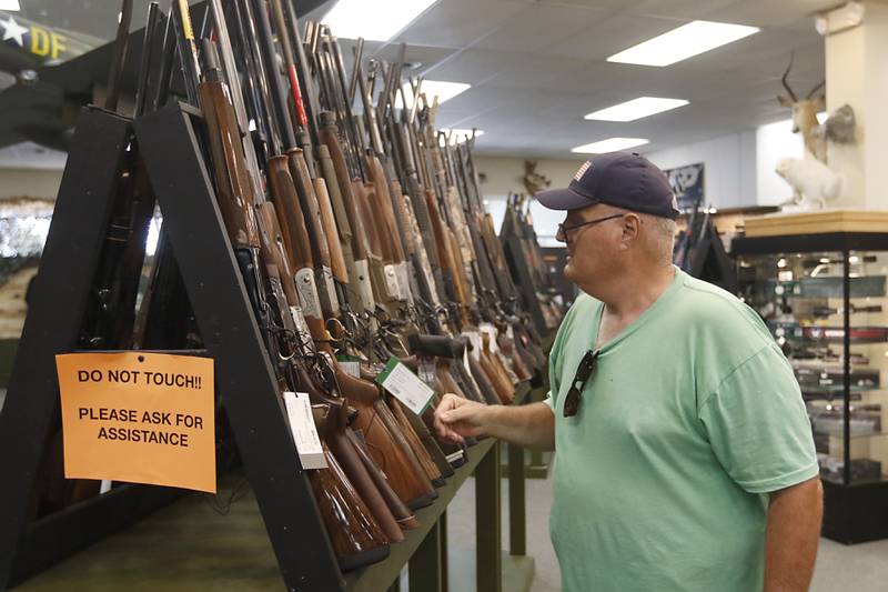 Brad Foote of Marengo looks at guns for sale on Friday, Aug. 11, 2023, at Marengo Guns in Marengo. The Illinois Supreme Court ruled a ban on high-powered rifles and high-capacity magazines did not violate clauses of the Illinois Constitution aimed at ensuring laws are equally applied to all.