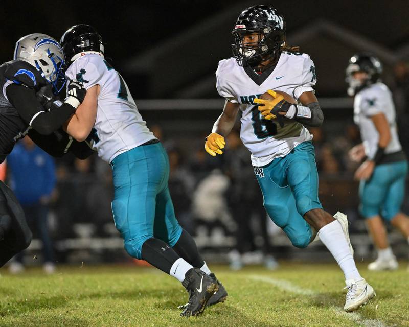 Woodstock North's Max Dennison looks for an opening early in the first quarter of their game against Kishwaukee River Conference and crosstown rival Woodstock on Friday, Oct. 25, 2024 at Woodstock H.S.