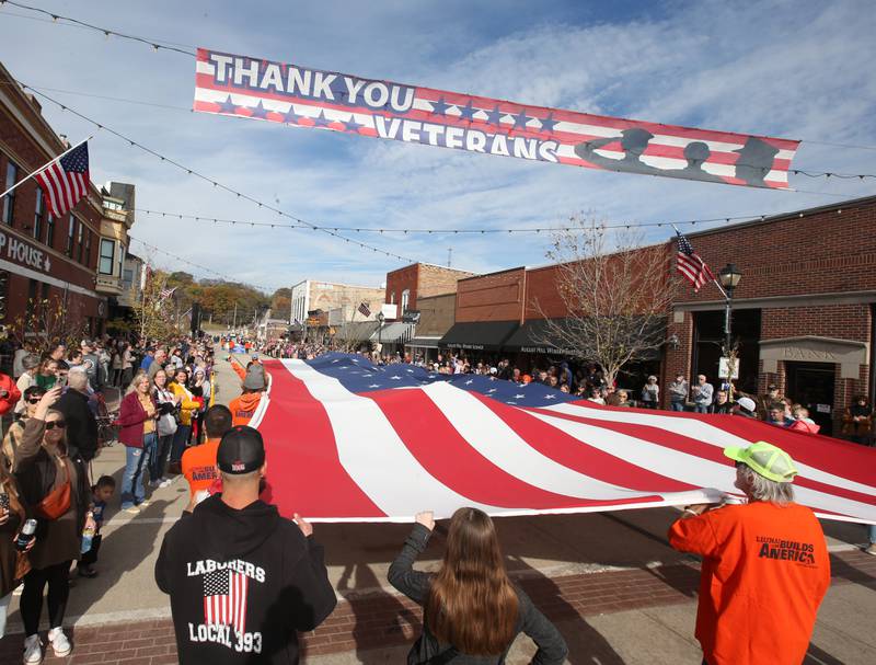 Laborers with Local 393 carry a large American Flag down Mill Street during the 16th annual Utica Veterans Parade and Air Show on Sunday Nov. 5, 2023 downtown Utica.