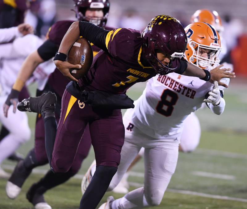 Montini quarterback Israel Abrams moves past Rochester's Xander Bridge during the IHSA Class 4A state championship game on Friday, Nov. 28, 2025 in Normal.