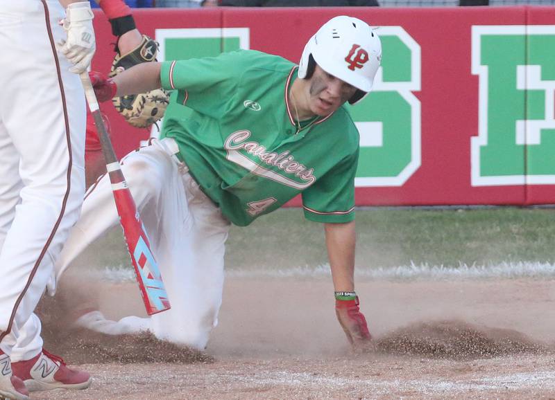 L-P's Jack Jereb reaches home plate to score the teams first run against Ottawa at Huby Sarver Field inside the L-P Athletic Complex on Tuesday, April 23, 2024 in La Salle.