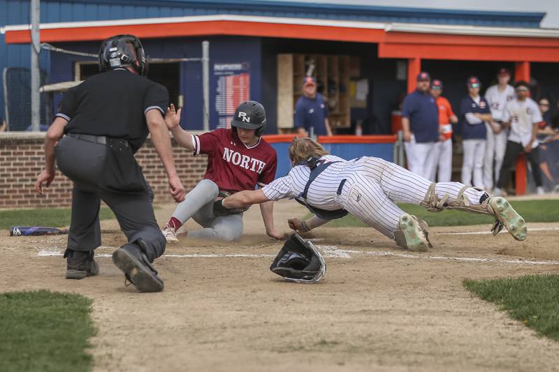 Plainfield North's Hayden Datwyler (5) slides safely into home during baseball game between Plainfield North at Oswego, Thursday, April 24, 2025 in Oswego.