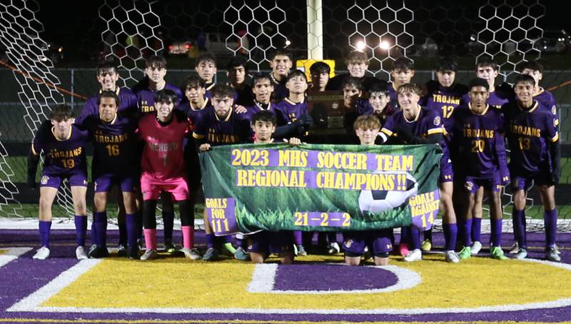 Members of the Mendota boys soccer team pose for a photo with their Regional Championship banner during the Class 1A Regional game on Wednesday Oct. 18, 2023 at Mendota High School.