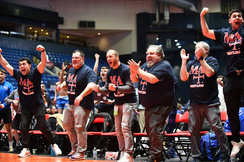 The Marmion Academy bench erupts as Colton Wyller secured a 113-pound match victory over Kristian DeClercq of Hononegah during the IHSA Dual Team State Finals in Bloomington on Saturday, March 1.