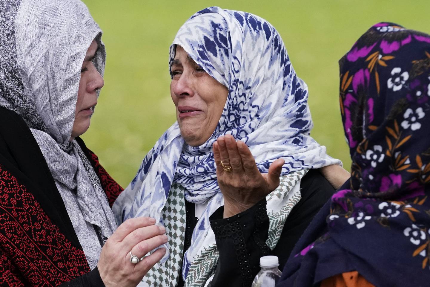 Muslim community members cry at the grave of Wadea Al Fayoume in LaGrange, Ill., Monday, Oct. 16, 2023.