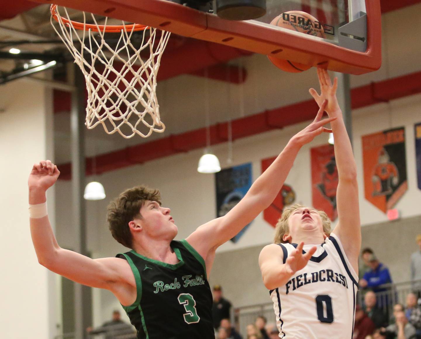 Fieldcrest's Jordan Heider eyes the hoop as Rock Falls's Ryken Howard defends during the 49th annual Colmone Classic on Saturday, Dec. 9, 2023 at Hall High School.