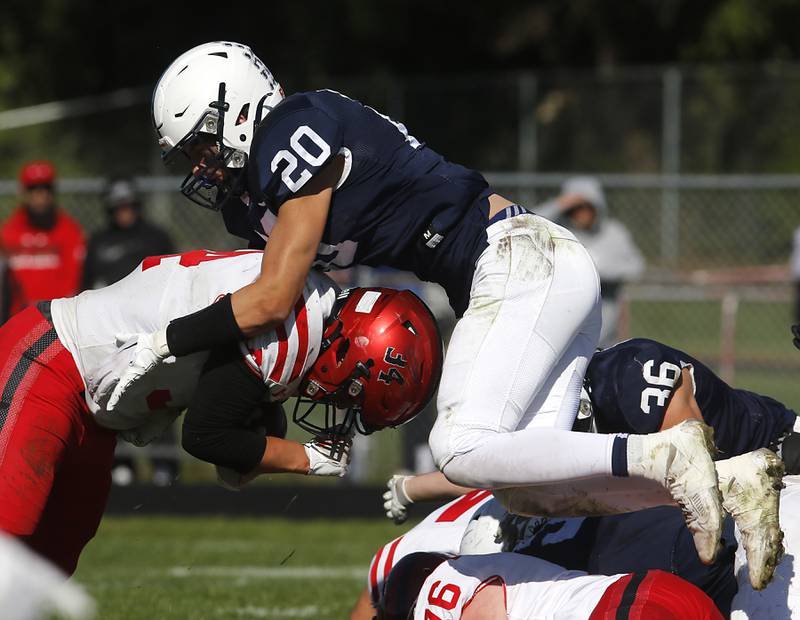 Cary-Grove's Connor Anderson jumps on top of h34\ as he tries to tackle him during a Fox Valley Conference football game on Saturday, Oct. 7, 2023, at Cary-Grove High School.