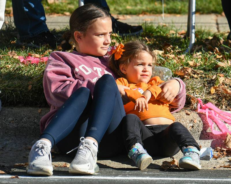 Family friends Holland Lundeen, 10, of Sycamore and Lillian Heavener, 3, of North Aurora watch the Pumpkin Parade on Sunday Oct. 27, 2024, held in downtown Sycamore.