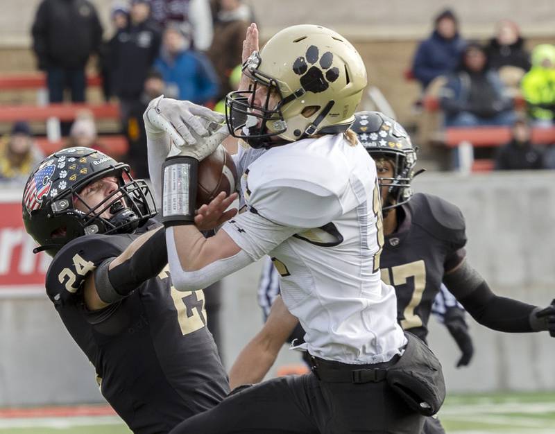 Lena-Winslow's Lucas Fye works defends Camp Point's Jack Thompson on a pass completion to Thompson in the 2023 Class 1A state football championship game at Hancock Stadium in Normal.