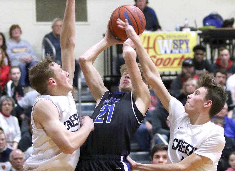 Newark junior Jared Slivka tries to score between Indian Creek's Cooper Larsen (left) and Michael Lampson during the Little Ten Conference Tournament championship game this past February in Somonauk.