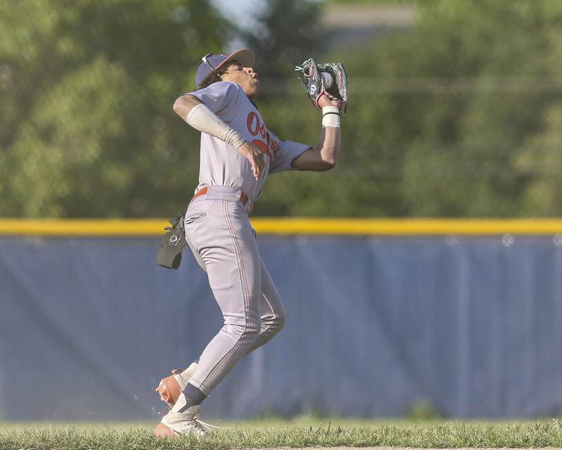 Oswego's Kam Jenkins (25) catches a popup at short during baseball game between Oswego East at Oswego. Monday, May 19, 2025 in Oswego.