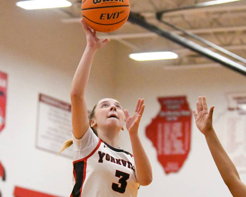 Yorkville's Alayna Demas (3) makes a layup during the game on Thursday Dec. 18, 2025, while being defended by Oswego East held at Yorkville High School.