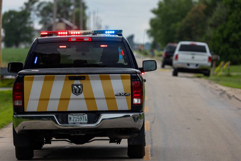 Law enforcement vehicle drives down 42nd road towards crime scene of double homicide on Thursday, July 17, 2025 in Sheridan.