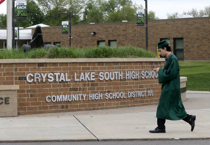 Jonathan Peres checks his phone Saturday, May 13, 2023, before the graduation ceremony for class of 2023 to begin at Crystal Lake South High School in Crystal Lake.