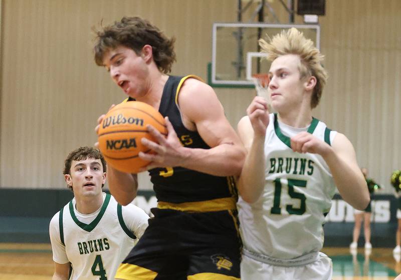 Putnam County's Johnathon Stunkel grabs a rebound over St. Bede's Geno Dinges during the Class 1A Regional quarterfinal game on Monday, Feb. 23, 2026 at St. Bede Academy.